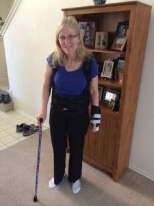 Me with back brace, wrist brace, and cane