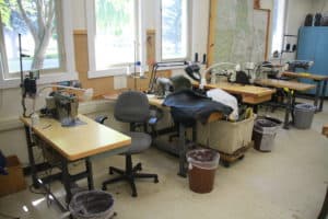 shows sewing room where all smoke jumpers must examine parachutes and make repairs using sewing machines.